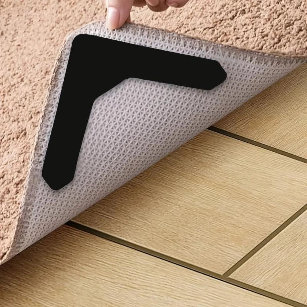 Tape applied under rug corner to prevent curling