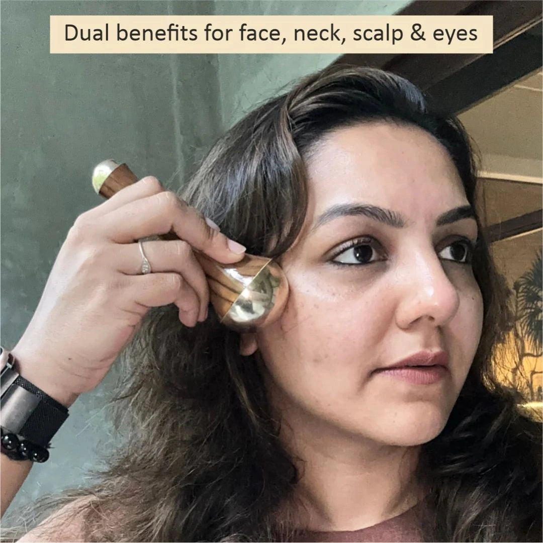 Woman massaging face with Kansa wand
